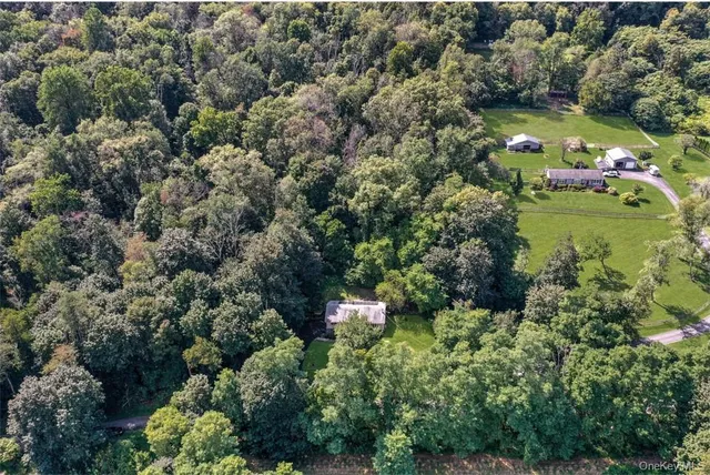 an aerial view of a house with a yard and lake view