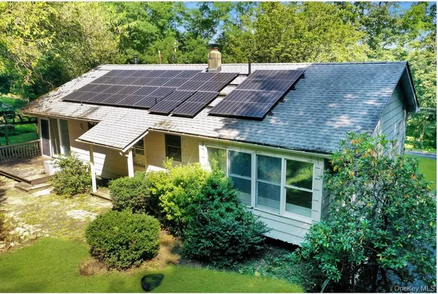 a aerial view of a house with a yard and potted plants