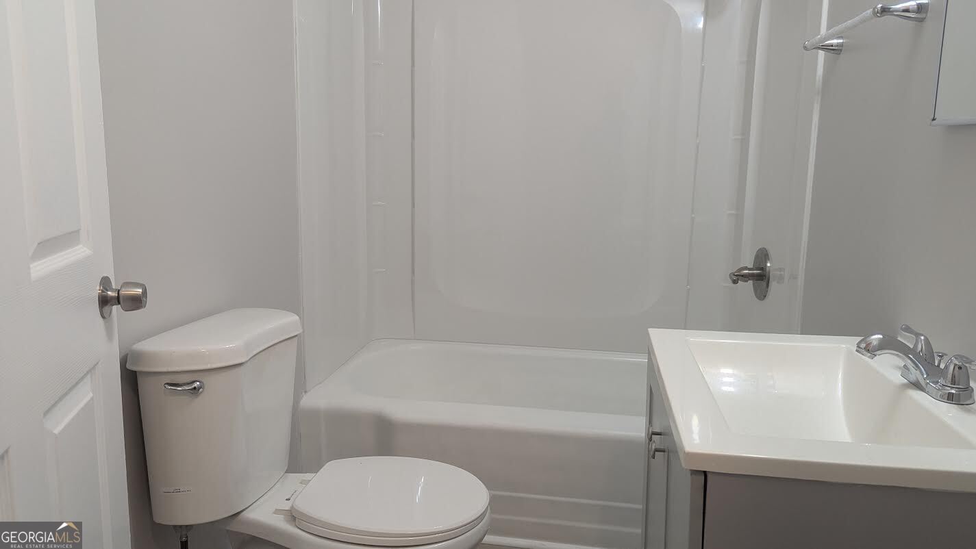 3444 Mogul Road Macon, GA 31217 - Photo 3 of 7 a white toilet sitting next to a bath tub