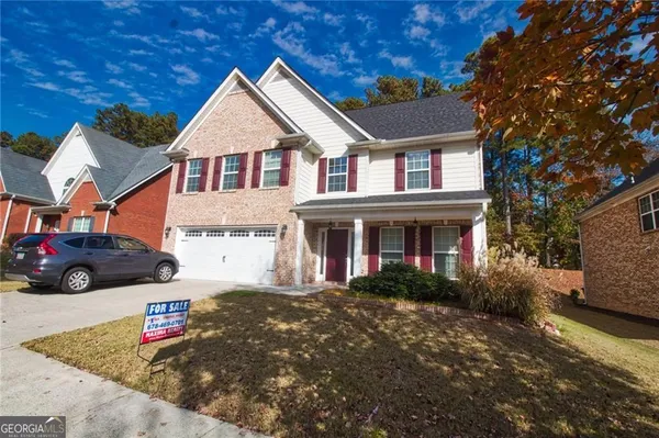 a front view of a house with a yard