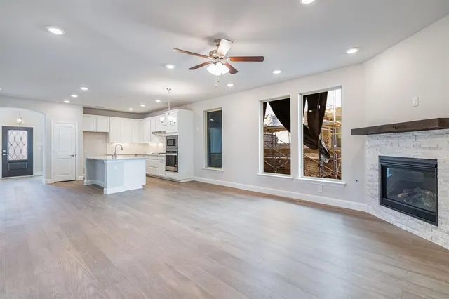 a view of a kitchen with a sink and a fireplace