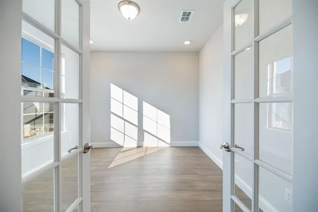 wooden floor in an empty room with a window