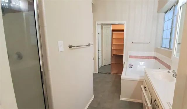 a bathroom with a bathtub and a shower