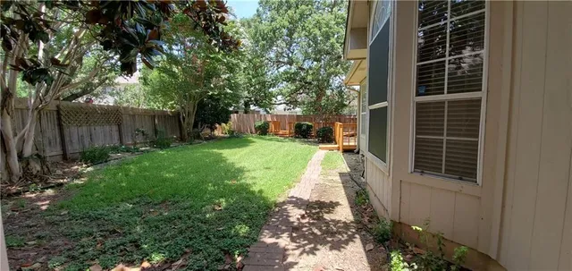 a view of a pathway with a house in the background