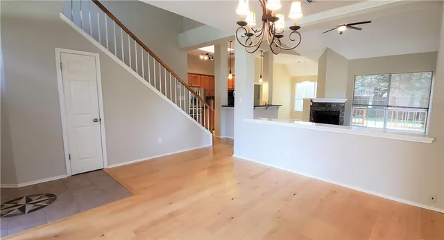 a view of a livingroom with wooden floor and stairs