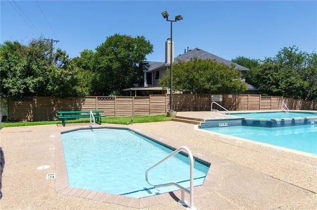 a view of a swimming pool with a yard