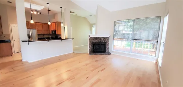 a view of a kitchen with a sink and a fireplace