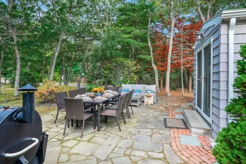a view of a patio with a table and chairs