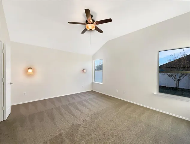 a view of a livingroom with a ceiling fan and wooden floor