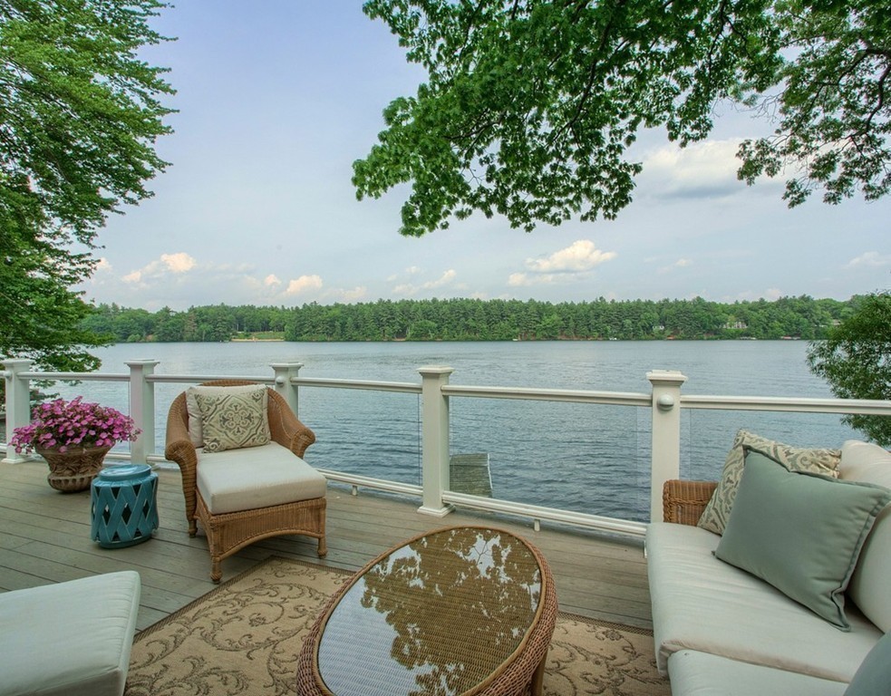 128-129 Barton Road Stow, MA 01775 - Photo 3 of 30 a view of a lake with couches and wooden floor