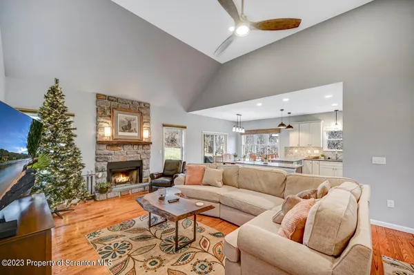a living room with furniture kitchen and a chandelier