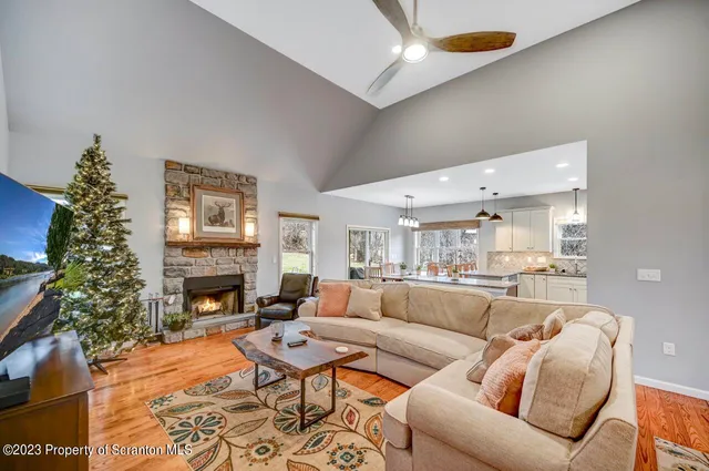 a living room with furniture kitchen and a chandelier