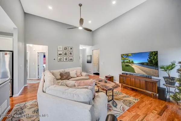 a living room with furniture and a chandelier