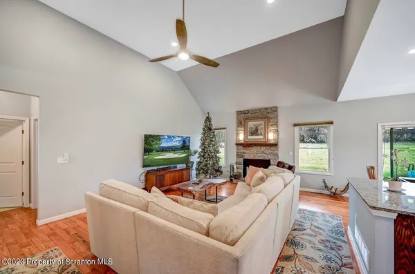 a kitchen with stainless steel appliances kitchen island granite countertop a table chairs and a refrigerator