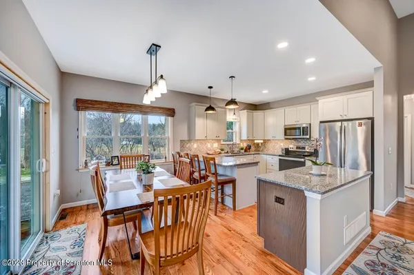 a kitchen with granite countertop sink stove and cabinets