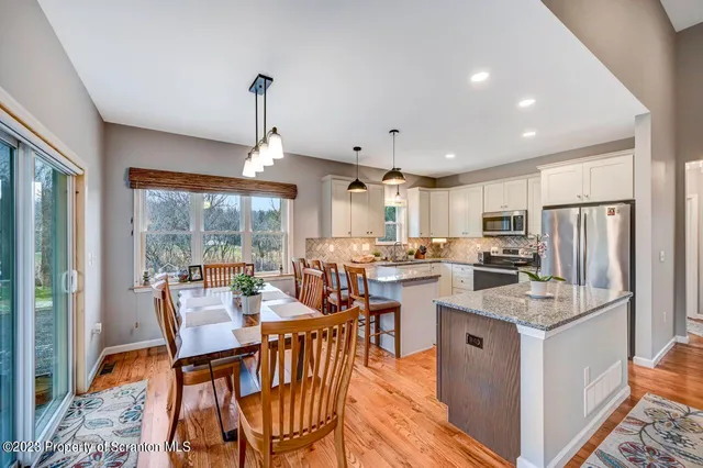a kitchen with granite countertop sink stove and cabinets