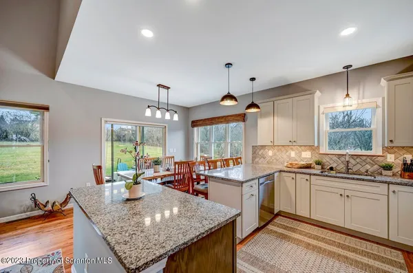 a kitchen with stainless steel appliances a sink stove and cabinets