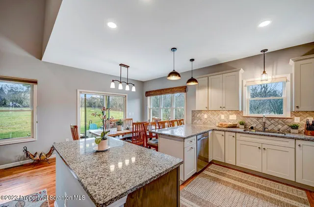 a kitchen with stainless steel appliances a sink stove and cabinets