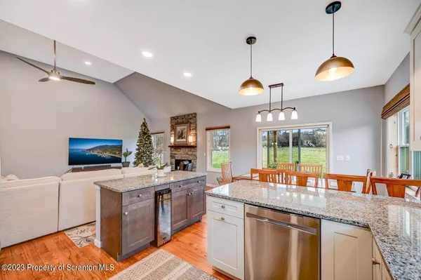 a large kitchen with granite countertop a large window and a counter space
