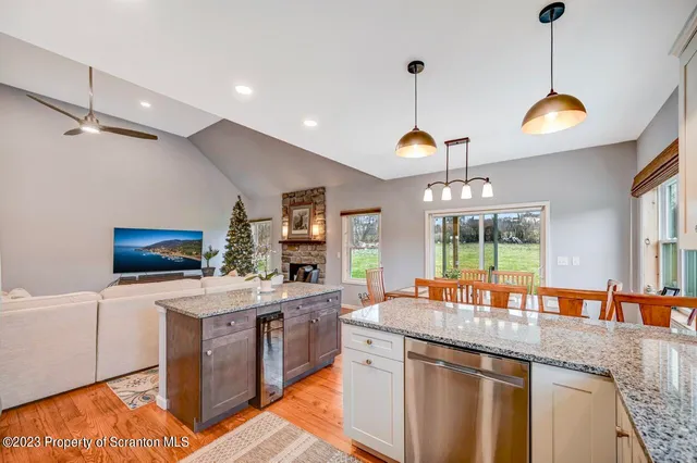 a large kitchen with granite countertop a large window and a counter space