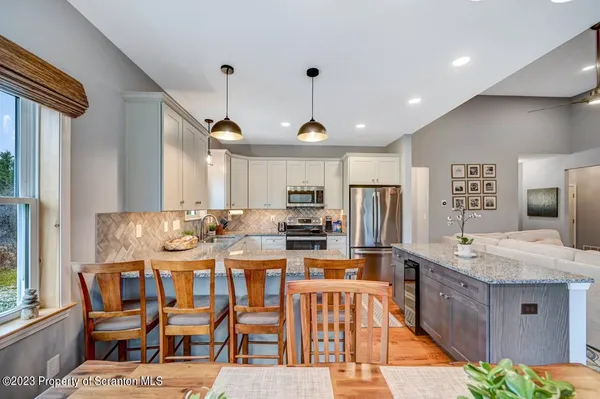 a kitchen with stainless steel appliances granite countertop a stove a sink a refrigerator and a refrigerator