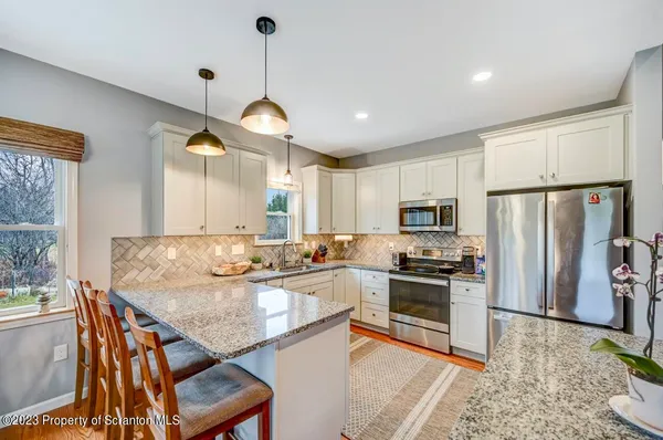 a view of a dining room with furniture large windows and wooden floor