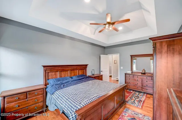 a bedroom with a bed and dresser with mirror