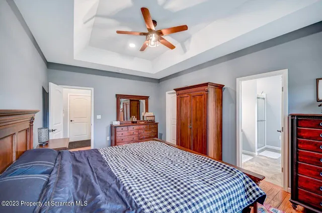 a bathroom with a granite countertop sink a mirror and a shower