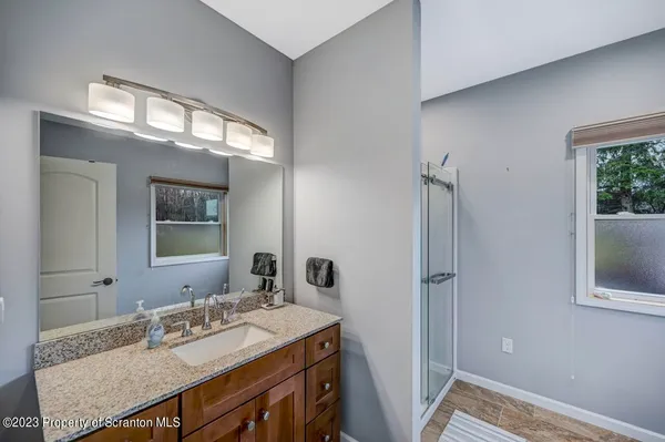 a bathroom with a shower and a mirror