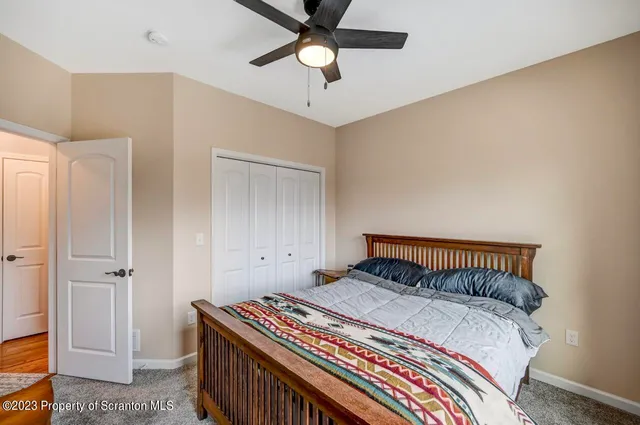 a bathroom with a granite countertop sink toilet a shower curtain and a bath tub