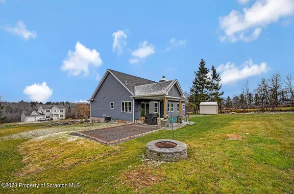 a view of a house with swimming pool and yard