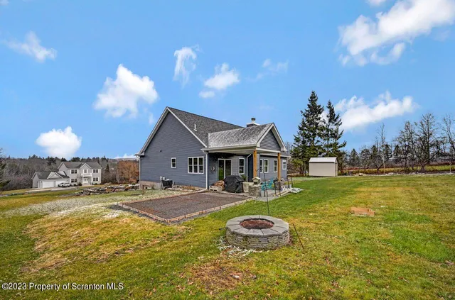a view of a house with swimming pool and yard