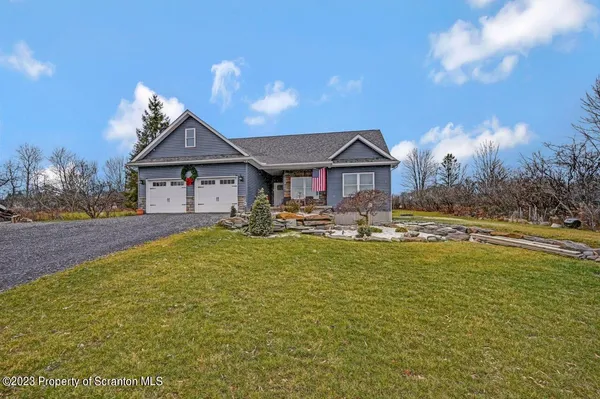 a front view of a house with yard and green space