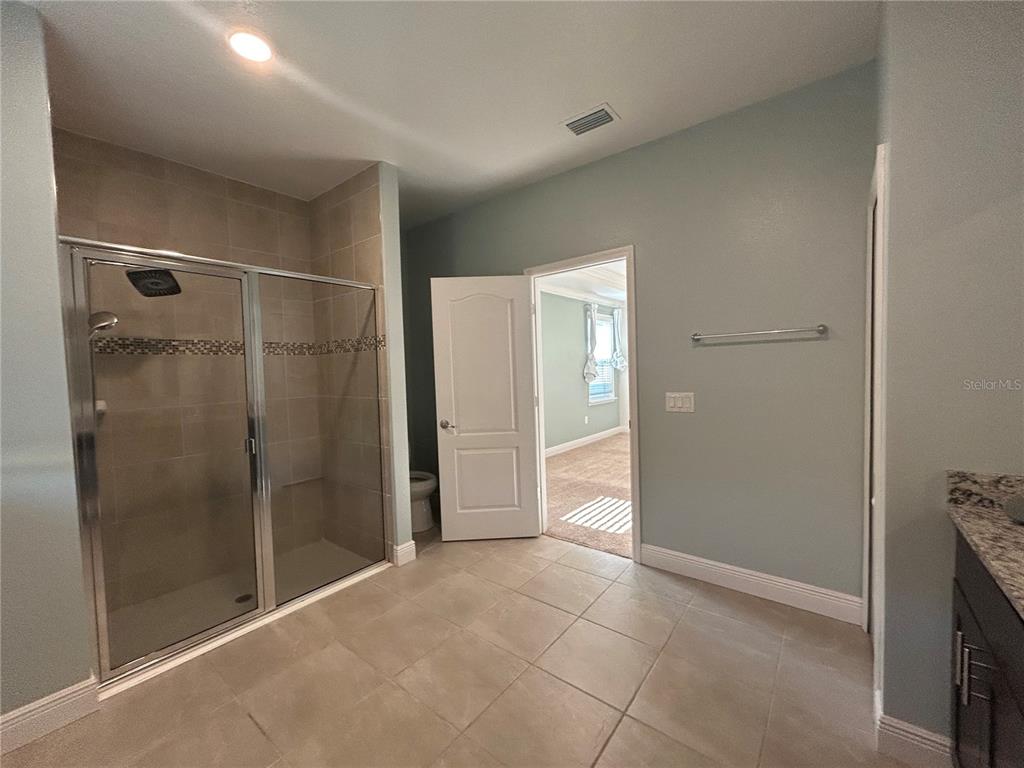 24470 Northwest 6th Road Newberry, FL 32669 - Photo 13 of 22 a bathroom with a shower and a glass door
