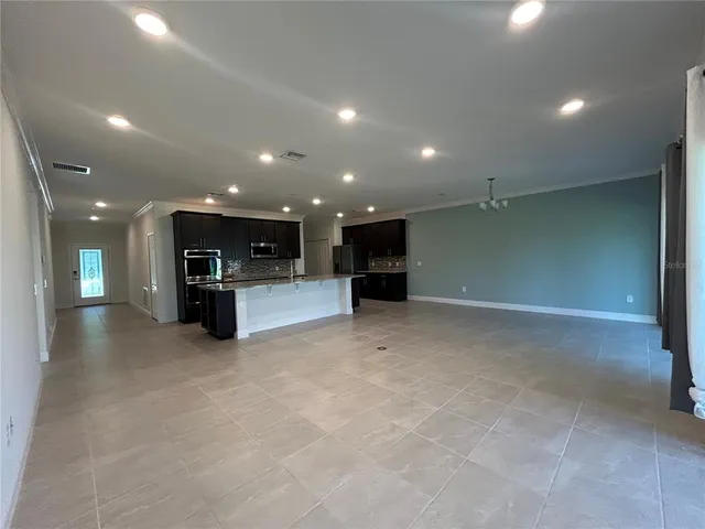 a view of kitchen with furniture and stainless steel appliances