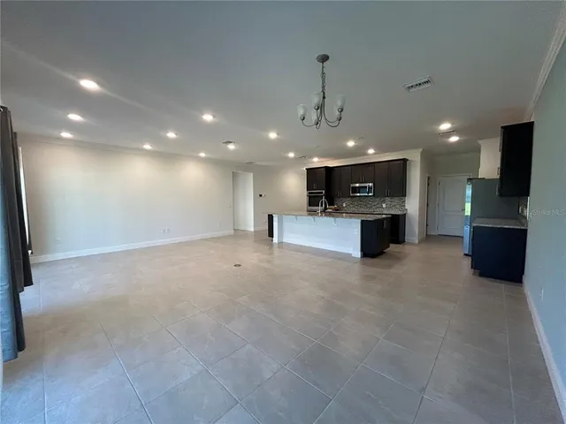 a view of kitchen with a sink and a stove top oven