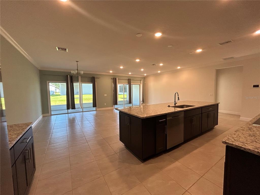 24470 Northwest 6th Road Newberry, FL 32669 - Photo 8 of 22 a kitchen with stainless steel appliances granite countertop a refrigerator and a sink