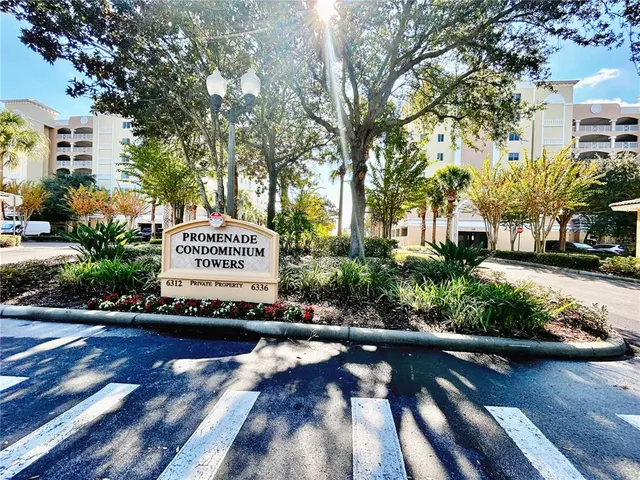 a front view of a house with a garden and lake view