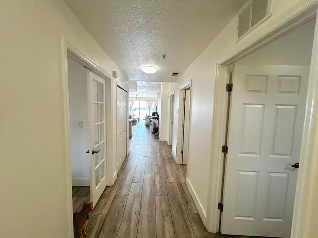 a bedroom with bed and flat tv screen on the dresser