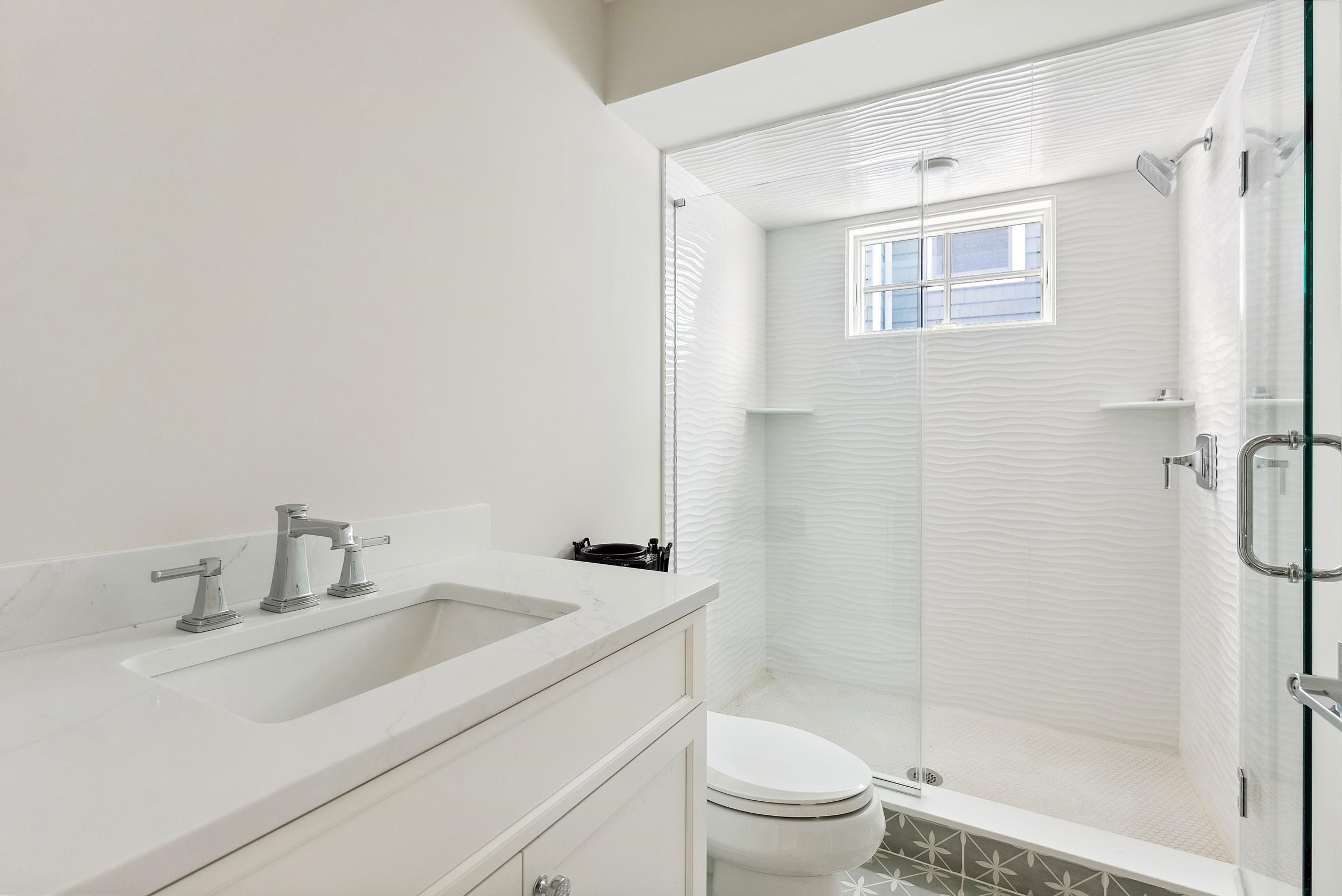 225 7th Street Avalon, NJ 08202 - Photo 13 of 37 a bathroom with a sink toilet and shower