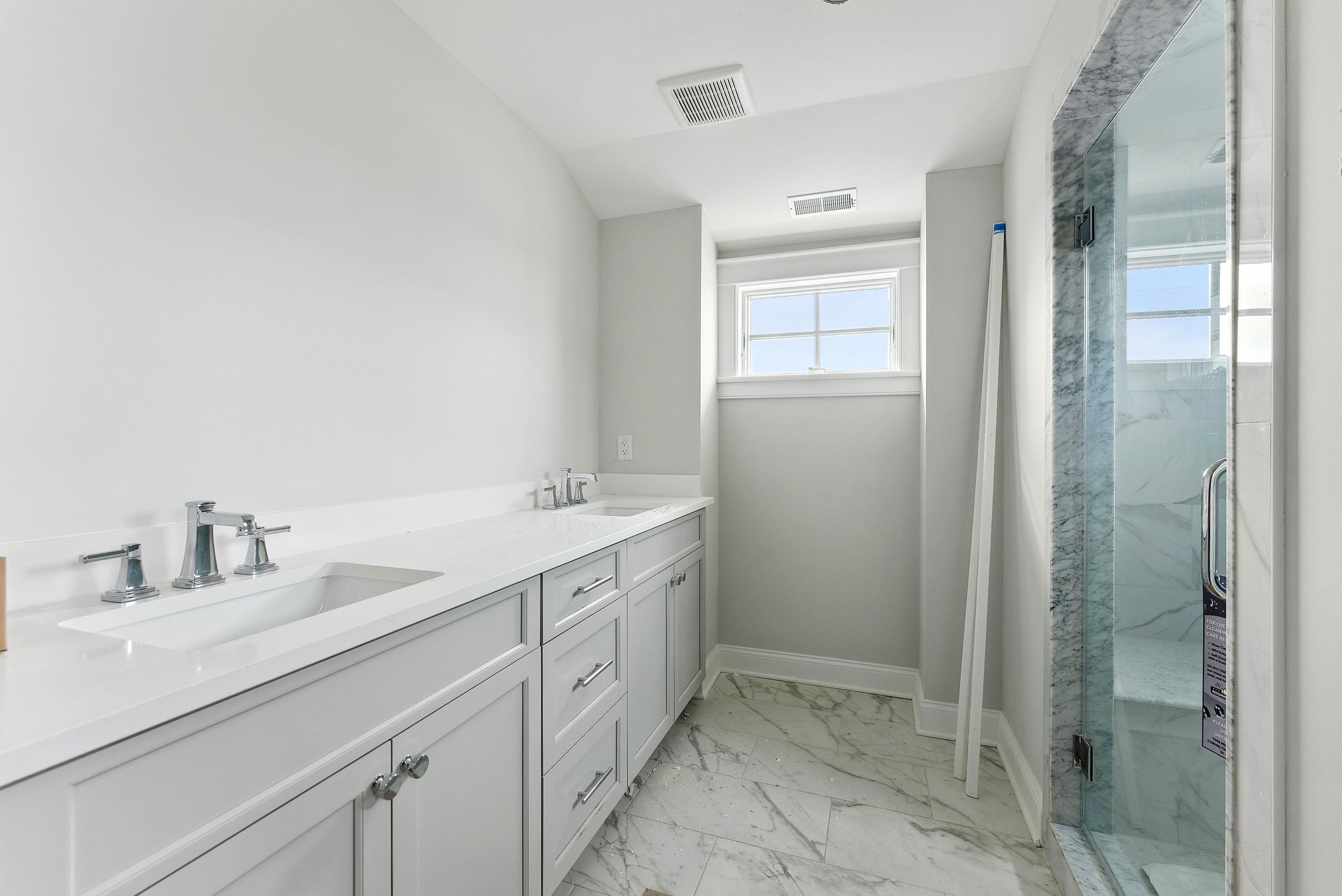 225 7th Street Avalon, NJ 08202 - Photo 16 of 37 a bathroom with a double vanity sink mirror and shower