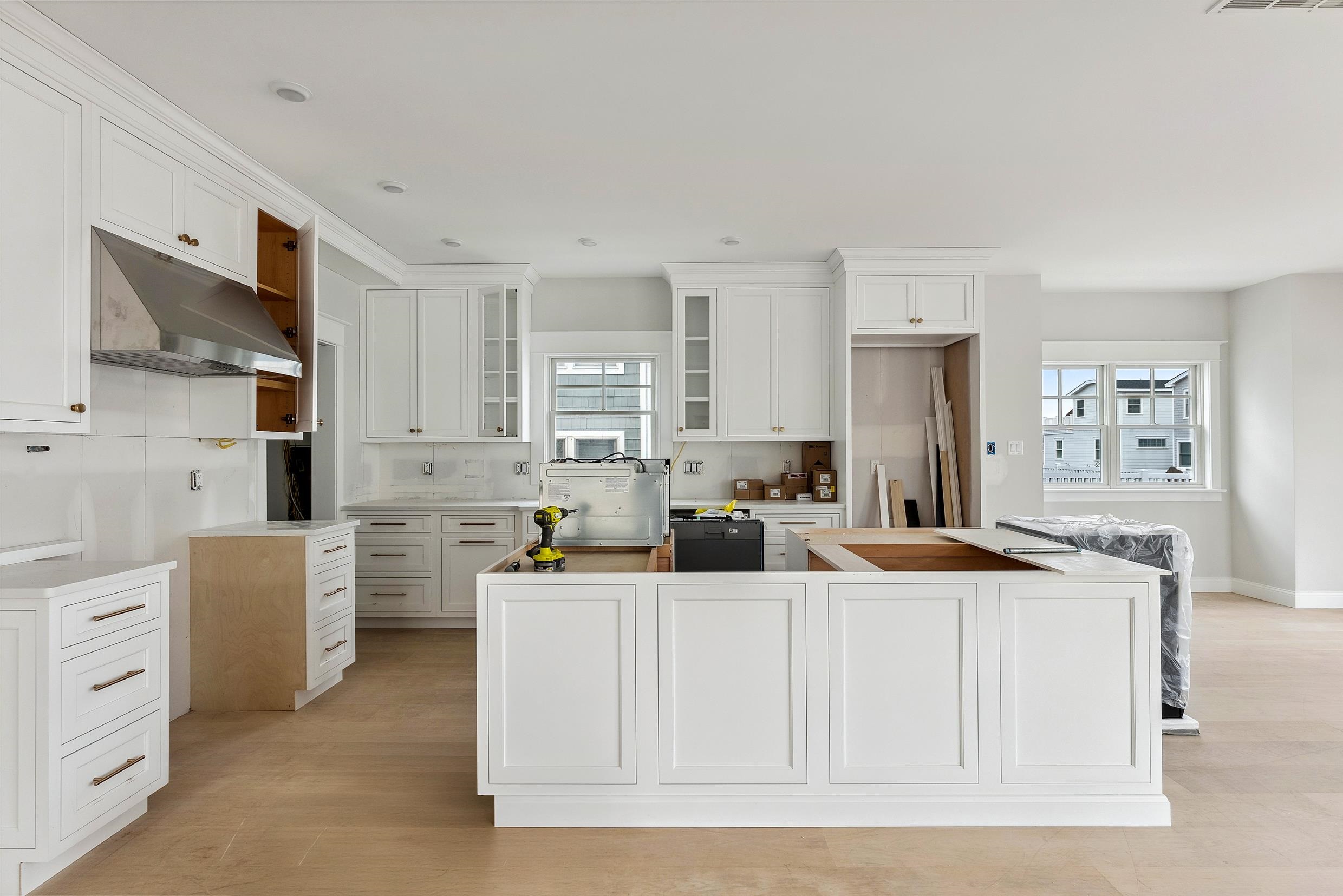 225 7th Street Avalon, NJ 08202 - Photo 3 of 37 a kitchen with stainless steel appliances kitchen island granite countertop a sink and cabinets