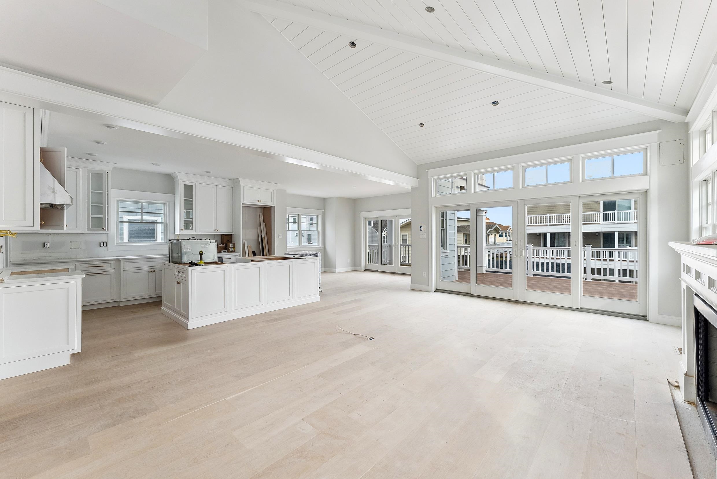 225 7th Street Avalon, NJ 08202 - Photo 5 of 37 a large white kitchen with kitchen island a sink a stove and a refrigerator