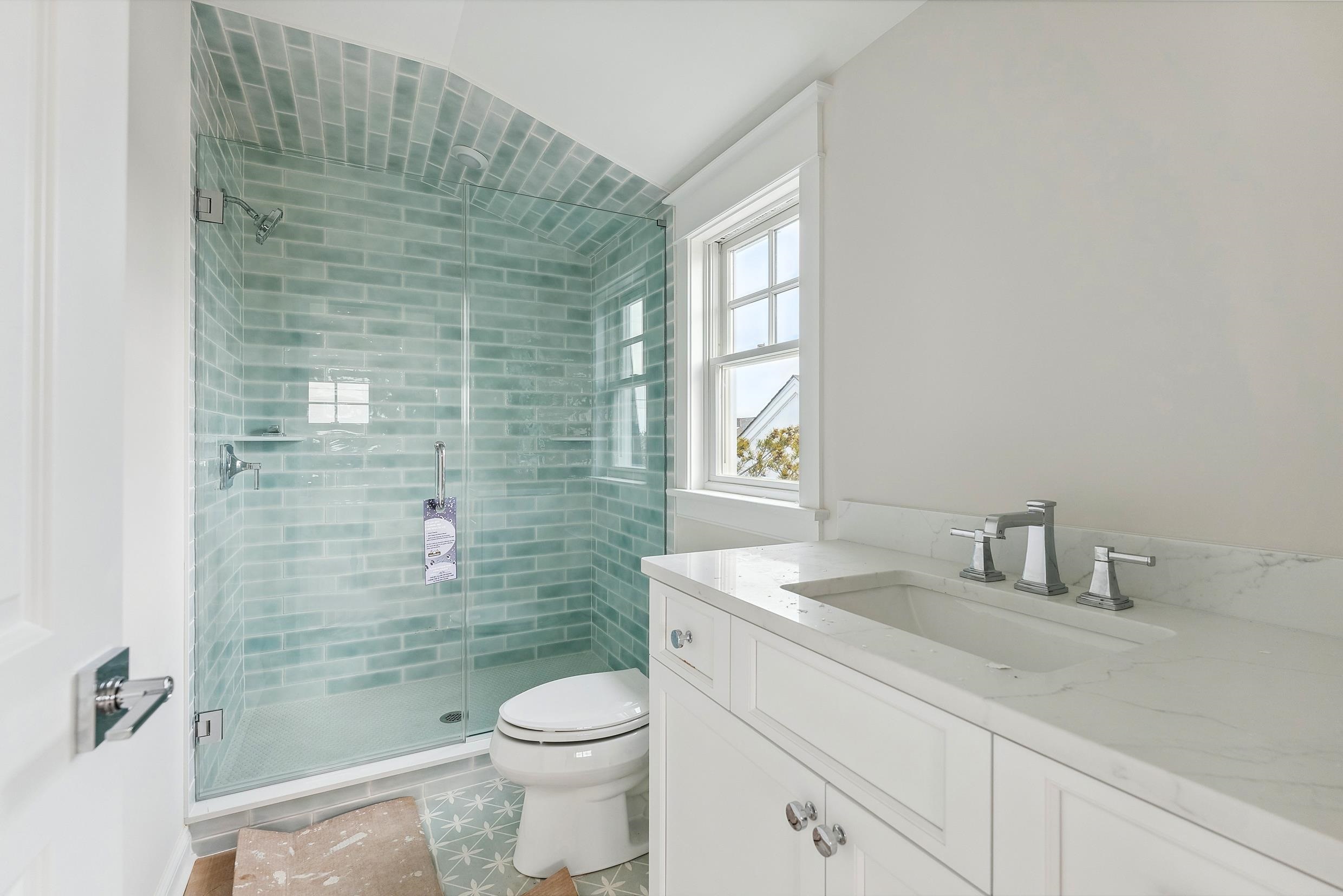 225 7th Street Avalon, NJ 08202 - Photo 8 of 37 a bathroom with a sink a toilet and shower