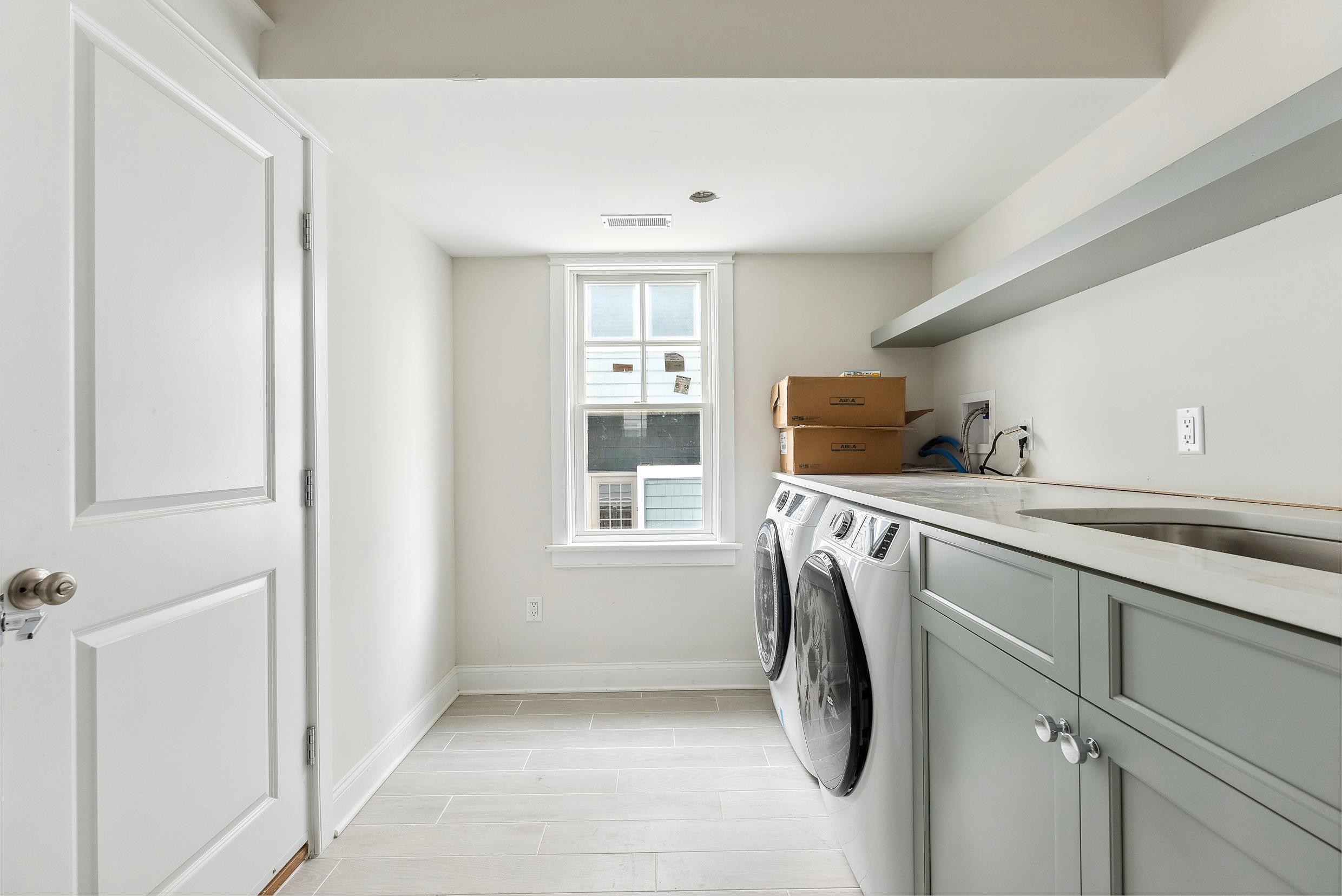 225 7th Street Avalon, NJ 08202 - Photo 10 of 37 a utility room with cabinets dryer and washer