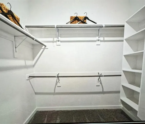 a bedroom with a bed and painting on the wall