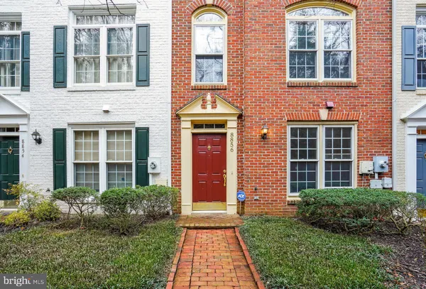 front view of a brick house with a large windows and a large window
