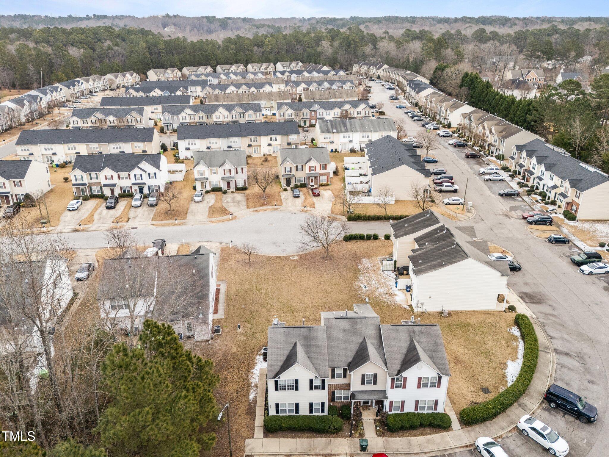 5901 San Marcos Way Raleigh, NC 27616 - Photo 18 of 19 Aerial view of townhome - bottom center building group of three. End/left unit adjacent to trees, sLARGE common area behind building.