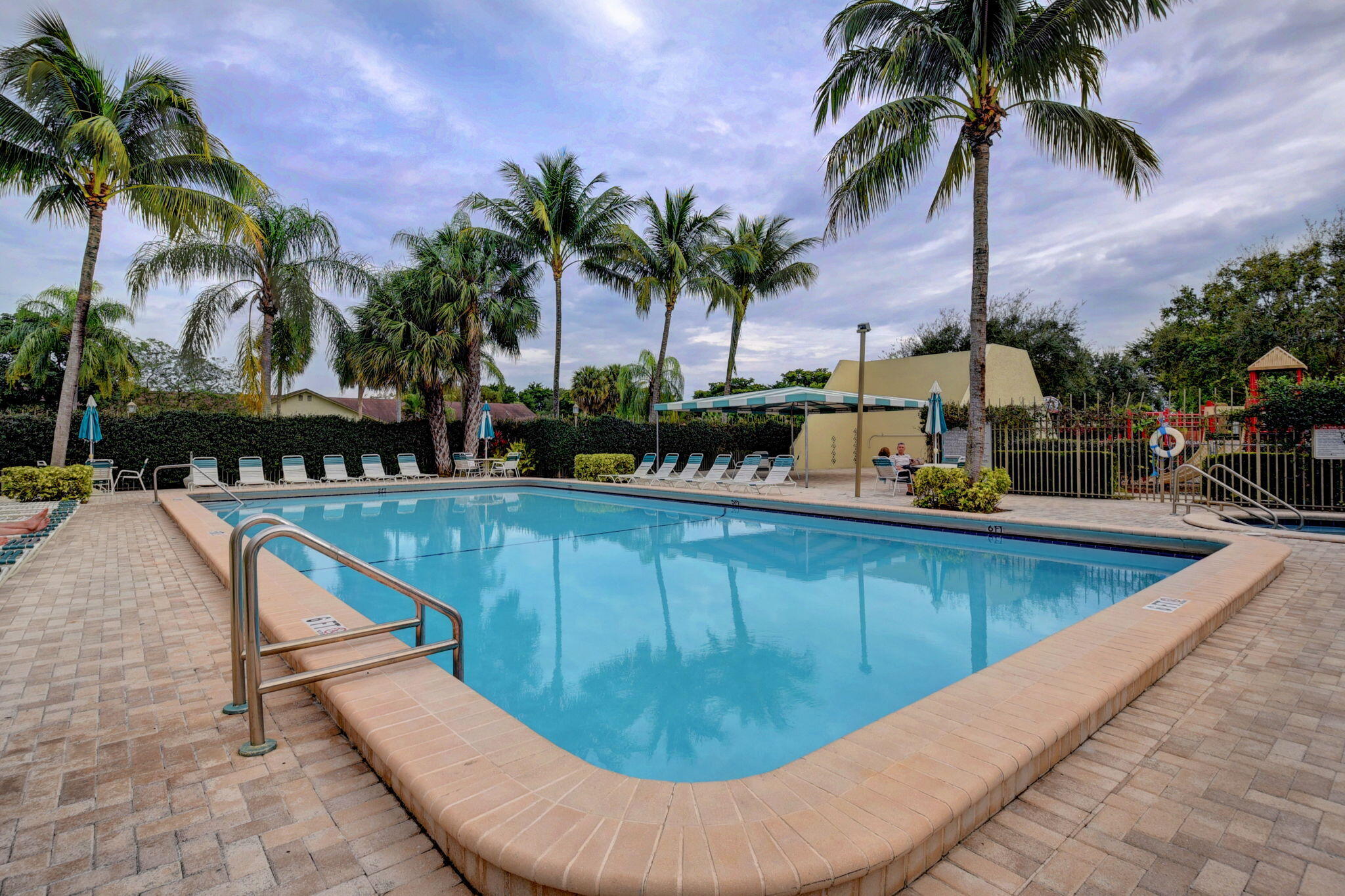 23398 Southwest 54th Way, Unit A Boca Raton, FL 33433 - Photo 25 of 29 a view of swimming pool with outdoor seating and palm tree
