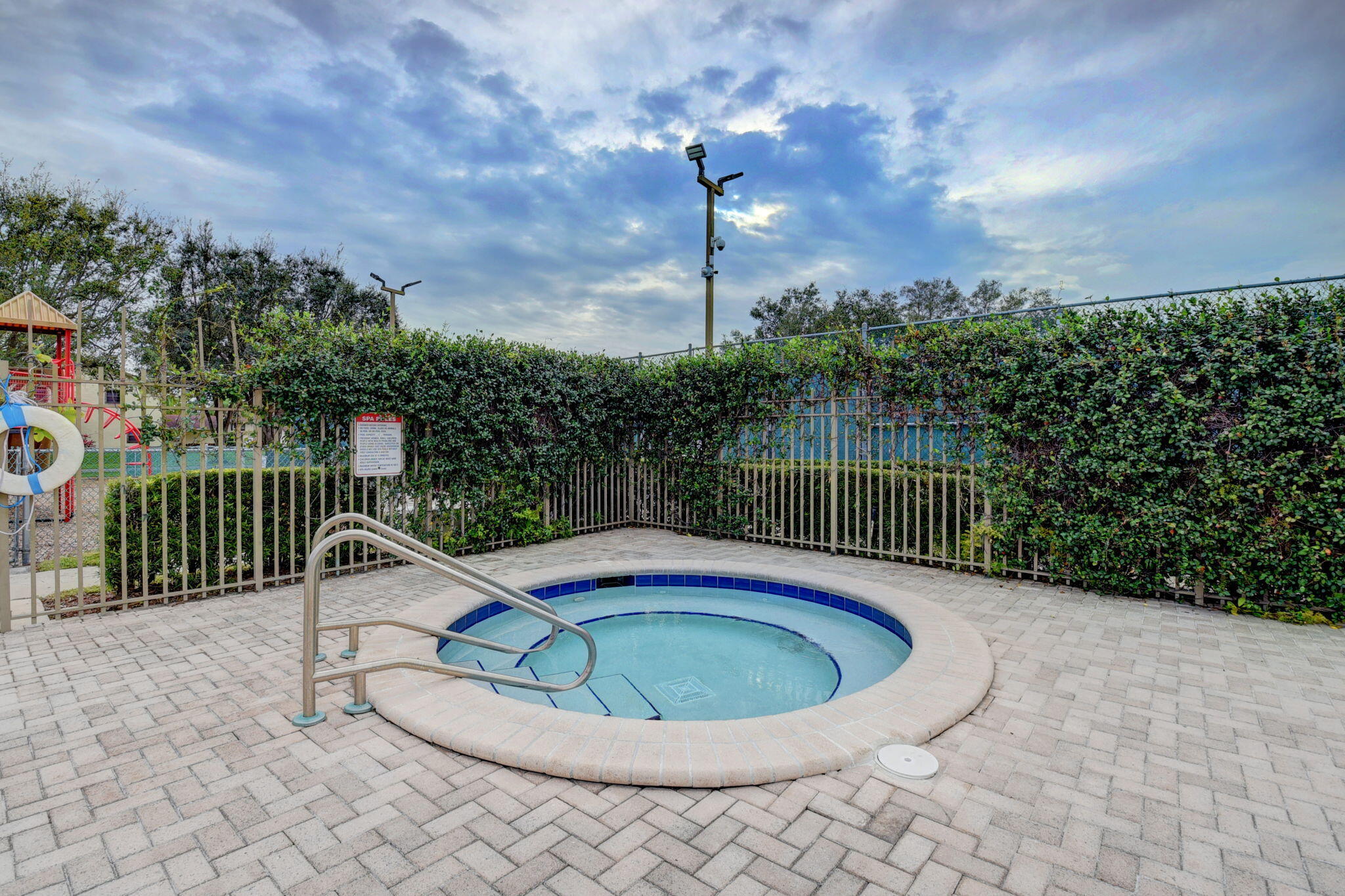 23398 Southwest 54th Way, Unit A Boca Raton, FL 33433 - Photo 26 of 29 a view of a swimming pool with a patio and a garden